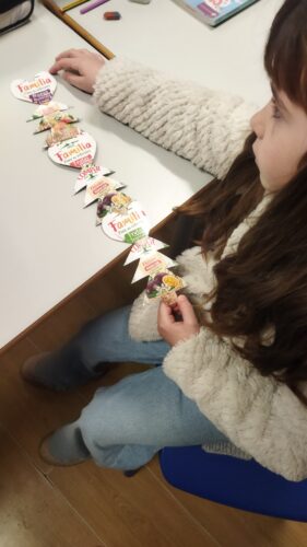 Os alunos mais novos recortaram pinheiros e corações aproveitando a palavra "família" das embalagens compal de litro.