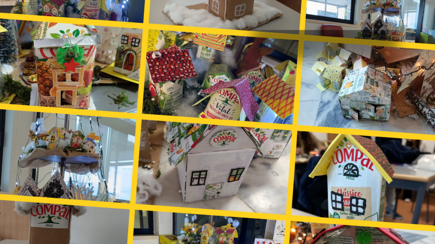 Foto 3 — Montagem da Aldeia de Natal<br/>Montagem coletiva da aldeia miniatura de Natal sobre a estrutura, integrando todas as casinhas construídas pelos alunos.